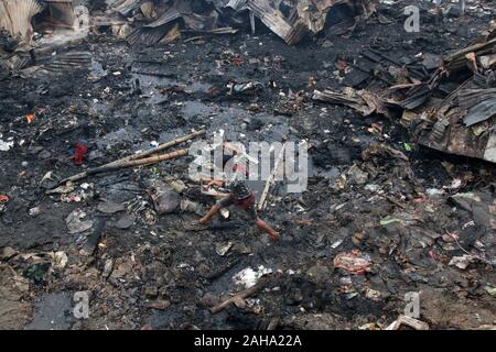 A boy walks through a fire devastated slum in Baunia badh area of ...