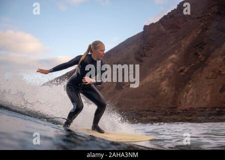 Surfer riding waves on the island of fuerteventura Stock Photo