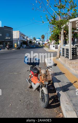 GREECE, KOS - MAY 31: Kardamena is a small town on the south coast of Kos and has all the makings of a great beach holiday.  Old motorbike on street n Stock Photo