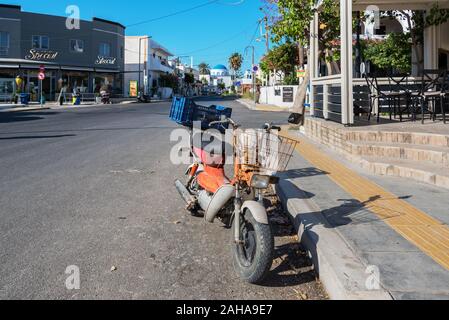 GREECE, KOS - MAY 31: Kardamena is a small town on the south coast of Kos and has all the makings of a great beach holiday.  Old motorbike on street n Stock Photo