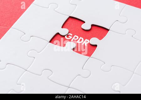 top view of white incomplete jigsaw puzzle pieces with gpdr lettering on red Stock Photo
