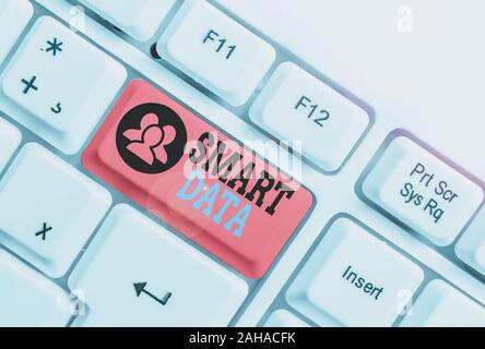 Writing note showing Smart Data. Business concept for digital information that is formatted for further consolidation White pc keyboard with note pape Stock Photo