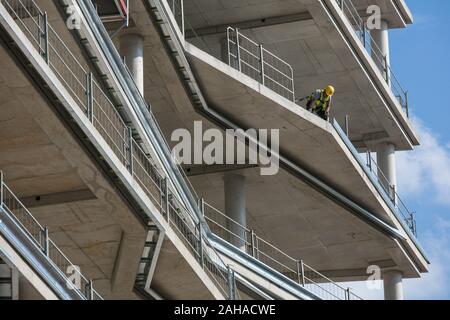 03.09.2018, Berlin, Berlin, Germany - Construction workers on the edge of a floor in the shell of the building for the cube berlin construction projec Stock Photo