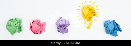 panoramic shot of multicolored crumpled paper balls and light bulb illustration on white background, business concept Stock Photo