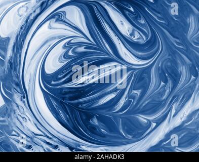 Abstract blue and white fluid background with swirls and waves pattern. Mixed liquid acrylic paint toned in trendy classic blue color of the year 2020 Stock Photo