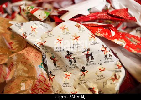 Used Christmas wrapping paper in a bundle. Stock Photo