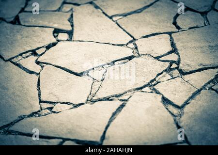 Road surface made of wild stones, blue tone. Stock Photo