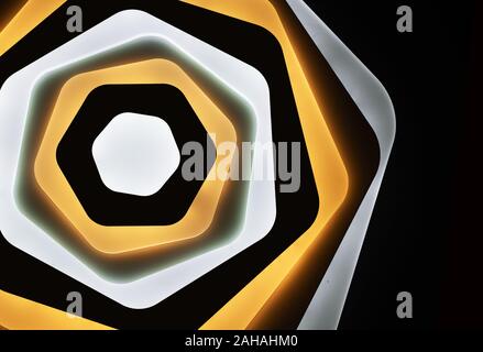 LED lamp with multi-colored glow on a black background. LED lighting in the interior. Stock Photo