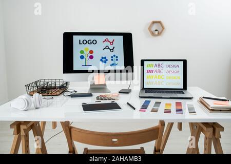 Working supplies and gadgets on workplace of contemporary freelance web designer Stock Photo