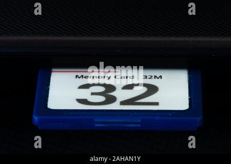 Low storage 32 MB micro compact flash memory card plugged into laptop Stock Photo