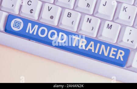 Handwriting text Mood Trainer. Conceptual photo a demonstrating who trains to alleviate mood disorders of a demonstrating White pc keyboard with empty Stock Photo
