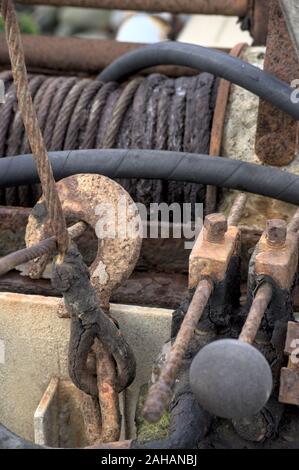 Close up of rusted hydraulic winch and cable with black tube Stock Photo