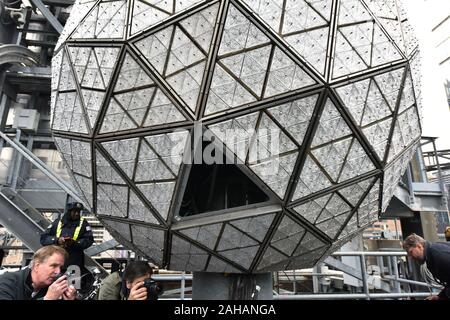 New York City, USA. 27th Dec, 2019. A section of the Waterford Crystal panel is removed from the Times Square New Year's Eve Ball atop One Times Square in New York, NY, December 27, 2019. The Times Square New Year's Eve Ball at 12 feet in diameter and weighing 11,875 lbs will be covered with a total of 2,688 “Gift of Goodwill” designed Waterford Crystal triangles. (Anthony Behar/Sipa USA) Credit: Sipa USA/Alamy Live News Stock Photo