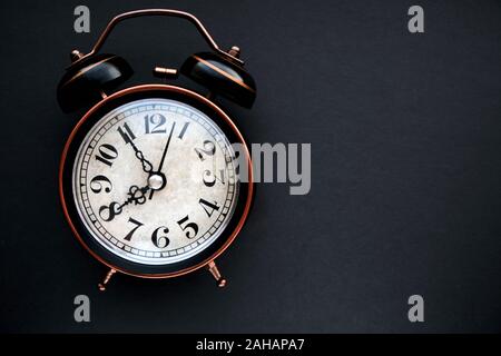 Old, vintage retro alarm clock on dark background Stock Photo