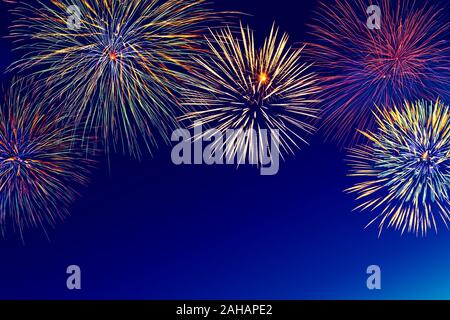 Colorful fireworks over night sky with copy space. Stock Photo
