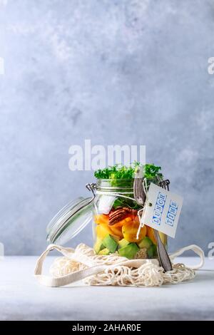 Homemade salad in glass jar with quinoa and vegetables with label lunch time no plastic and take away concept Stock Photo