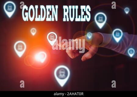 Writing note showing Golden Rules. Business concept for basic principle that should always follow to ensure success Woman wear formal work suit presen Stock Photo