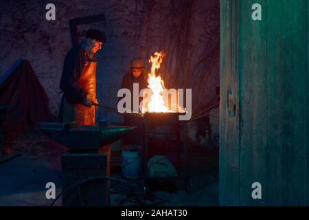 Italy, Sicily, Partinico, December 22/2019,beautiful living nativity scene in the Parrini district, blacksmith at work with his assistant Stock Photo