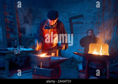 Italy, Sicily, Partinico, December 22/2019,beautiful living nativity scene in the Parrini district, blacksmith at work with his assistant Stock Photo