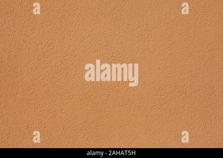 Dark beige textured wall, texture, background. Structural plaster, covered with water-based paint. Rough, uneven surface in beige color Stock Photo