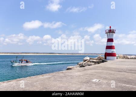Red white Lighthouse on the shore of Peniche Portugal Stock Photo