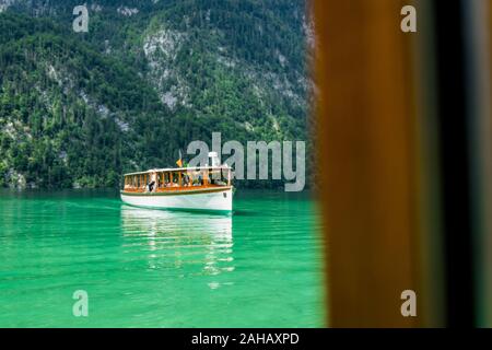 A tourist boat at the Koenigssee lake (Königssee) from the window of another tourist boat in Bavaria, Germany Stock Photo