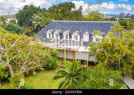 Lush tropical gardens and tiled roof of Eureka La Maison Creole old colonial house, Moka, Indian Ocean, Mauritius