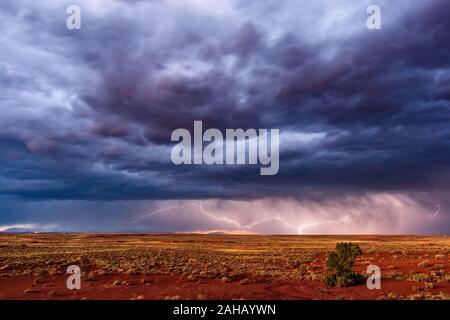 Distant thunderstorm with lightning and dramatic sky near Winslow, Arizona Stock Photo