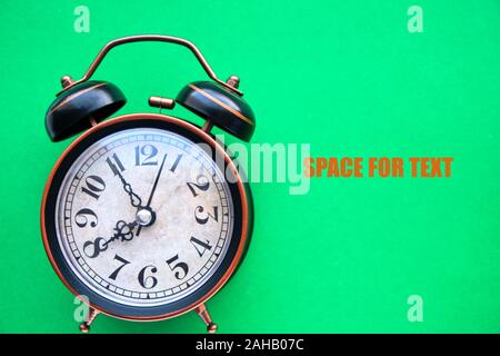 Old, vintage retro alarm clock on a bright green background Stock Photo