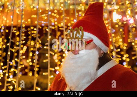 Moscow, Russia. 27th of December, 2019 People dressed as Father Frost (Russian Santa Claus) and Santa Claus take part in a parade in central Moscow as part of the Journey to Christmas winter festival, Russia Stock Photo