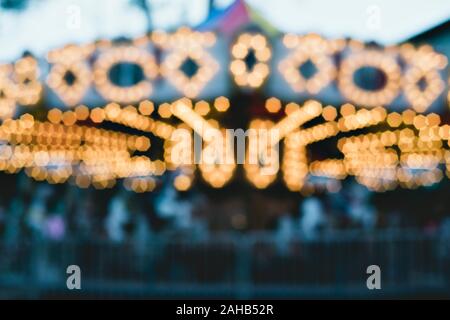 Carousel at night with blurred lighting.  Background concept - Abstract concept for winter fun