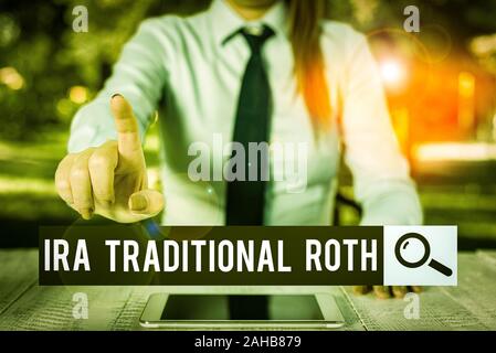 Handwriting text writing Ira Traditional Roth. Conceptual photo are tax deductible on both state and federal Female business person sitting by table a Stock Photo