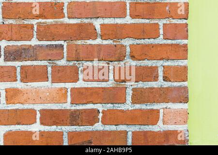 Red brick wall with green wall background texture Stock Photo