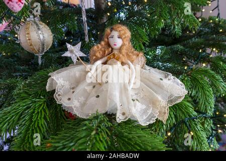 Classic Tobias and the Angel traditional Christmas fairy, home made out of vintage fabrics and materials, decorating a Christmas tree Stock Photo