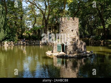 Sintra, Portugal - 21 August 2019: Stone tower bird house in lake in the gardens surrounding the Pena Palace Stock Photo