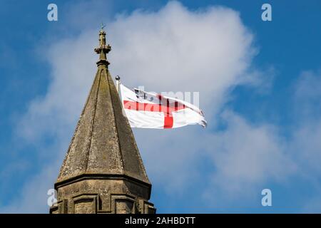 St George's flag flying from the top of a church spire Stock Photo