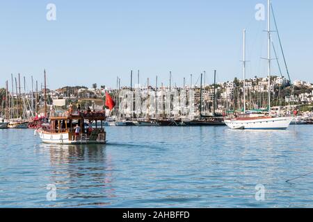 Bodrum, Turkey - September 23rd 2019: Boat leaving the busy harbour, As well as a large harbour there is also a marina. Stock Photo