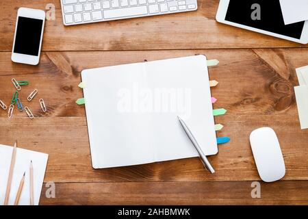 Open empty blank notebook organizer for planning on work table with devices Stock Photo