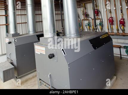 One million BTU propane fueled boilers at Good Harvest Farm on April 19, 2011 in Strasburg, PA completed Rural Energy for America Program (REAP) grant supported renovation six months ago that replaced an 80-year old structure with a new 4,000 sq. ft. facility that features energy efficient glass roof with curtains that block or trap heat, radiant heaters in or above the floor, and the replacement of an oil-fired hot-air furnaces with propane fueled boilers that supply fin-tube and cement embedded tube elements with hot water. Stock Photo