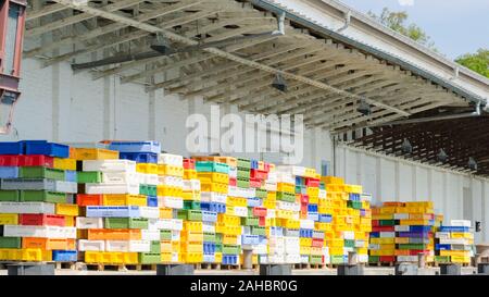 Many stacked colorful boxes in one warehouse Stock Photo