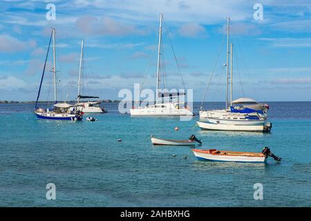 Group of sailing boats floating on blue water near coast of Bonaire Stock Photo