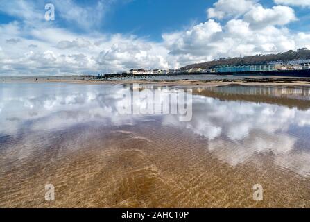 White clouds reflecting in the wet sand at Westward Ho! Beach, North Devon, UK Stock Photo