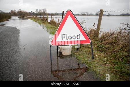 A flood sign on a flooded road near Ringwood in Hampshire. Stock Photo