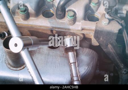 Car engine spark plug replacement Stock Photo