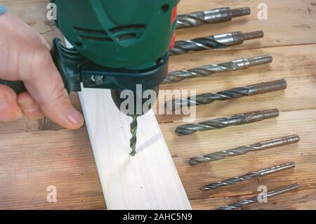 Drill work. Making hole into the wood with drill bit Stock Photo