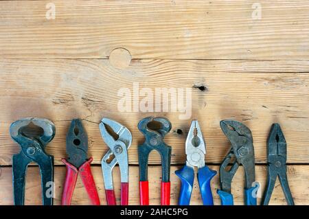 Set of pliers on wooden background Stock Photo