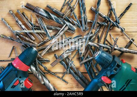 Set of drill bits on wooden background Stock Photo