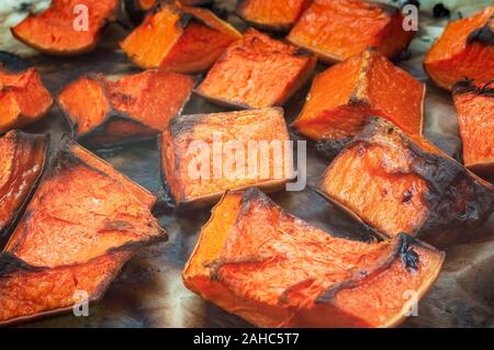 Roasted  pumpkin slices in oven pan Stock Photo