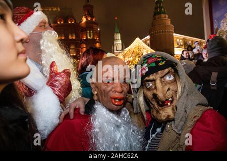 Moscow, Russia. 27th of December, 2019 People dressed fairy-tale costumes take part in New Year celebration near Moscow's Kremlin as part of the Journey to Christmas winter festival, Russia Stock Photo