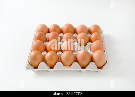 Carton of fresh brown eggs, one egg missing Stock Photo